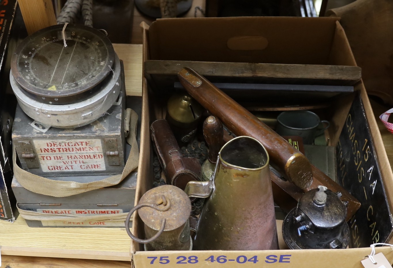 World War Two accessories to include an ARP hand-bell, three compasses and a brass loud-haler